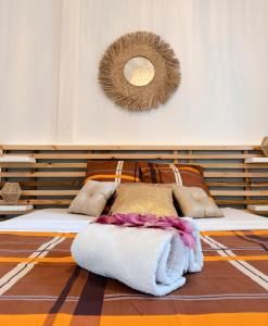 a bedroom with two beds and a mirror on the wall at Ti kè an mwen in Pointe-Noire