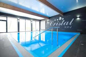 a swimming pool with a sign that reads british spa at Cristal SPA in Dźwirzyno