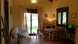 a living room with a couch and a table and a television at Casas Rurales Entrecastaños in Cangas de Onís