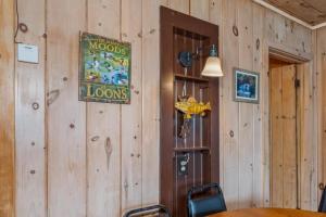 a dining room with a table and a sign on the wall at TB3 Thunder Bay Resort Cabin 3 in Phelps