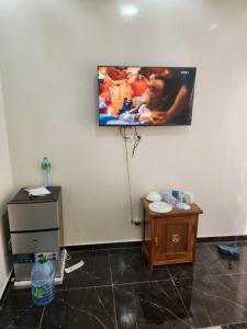 a room with a tv hanging on the wall at Gassama studio in Dakar