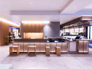 a large kitchen with a counter and stools at Tokyu Stay Sapporo in Sapporo