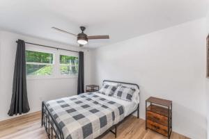 a bedroom with a bed and a ceiling fan at TB-13 Thunder Bay Resort Cabin 13 in Phelps