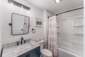 a bathroom with a sink and a toilet and a mirror at TB-13 Thunder Bay Resort Cabin 13 in Phelps +10 photos