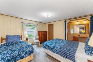 a bedroom with two beds and a sink at TB-15 Thunder Bay Resort Cabin15 in Phelps