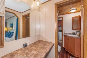 a bathroom with a sink and a toilet and a mirror at TB-15 Thunder Bay Resort Cabin15 in Phelps