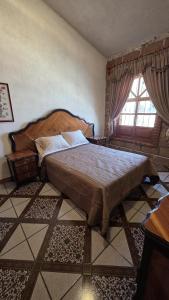 a bedroom with a large bed and a window at Casa Quijote in Chiautla