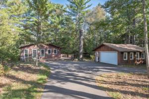a home with a garage and a house at Clover Pines in Eagle River