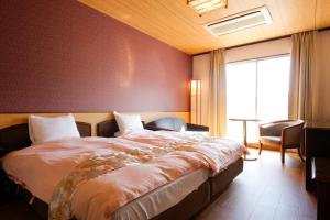 Rúm í herbergi á Hinotani Onsen Misugi Resort
