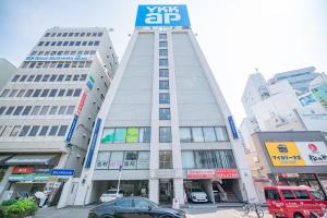 a tall building with a sign on top of it at Happy Osaka City in Osaka