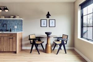 a kitchen with a table and chairs in a room at The Dylin in Madison