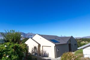 a white house with a gray roof at Arrowtown Dress Circle in Arrowtown