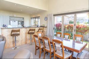 a dining room with a table and chairs at Arrowtown Dress Circle in Arrowtown