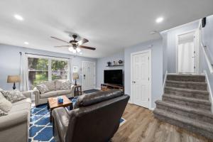 a living room with a couch and a tv at New Spacious Renovated Townhouse in Spring Hill