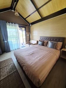 a bedroom with a large bed in a room at Walden Moon Resort in Ko Lanta Yai
