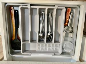 a drawer full of utensils in a refrigerator at Cozy Loft Studio with Balcony in Cebu City in Cebu City