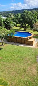 a large swimming pool in a yard with afficient sqorsenalsenalsenalsenalsenal at Studio a sofaia in Sainte-Rose