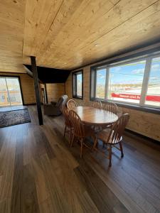 una sala da pranzo con tavolo, sedie e finestre di All About ME Loft a Montague 1 altra foto