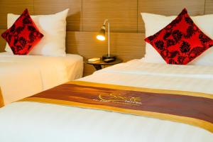 Ένα ή περισσότερα κρεβάτια σε δωμάτιο στο Smile Hotel