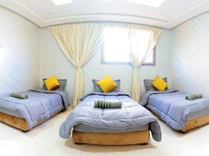 a bedroom with two beds and a window at Imsouane Wave Residences in Imsouane