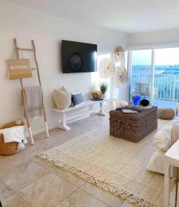 a living room with a tv on the wall at Your Happy Place ON THE BEACH! in Key Colony Beach