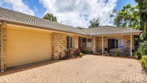 a brick house with a garage at Serenity in Corlette