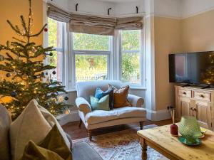 a living room with a christmas tree and a couch at The Front House in Great Malvern +10 photos