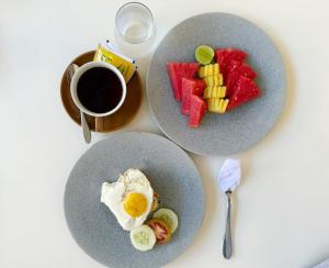 a table with two plates of food and a cup of coffee at Airindah Villa in Gili Islands