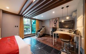 a bedroom with a bed and a desk in a room at R Hotel in Bucheon