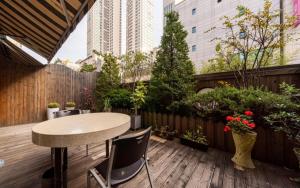 a patio with a table and chairs on a wooden deck at R Hotel in Bucheon