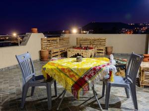 a table with two chairs and a blanket on a patio at Imsouane Wave Residences in Imsouane
