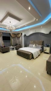 a large bedroom with a bed and a living room at Suite Room with big balcony in Al Rahba