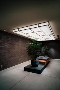 a room with two potted plants on a bench at KIORI Hotel Takakura in Kyoto