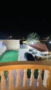 a view from a balcony of a parking lot at night at Suite Room with big balcony in Al Rahba