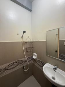 a bathroom with a sink and a mirror at Westlinehomestay in Puerto Princesa City +6 photos