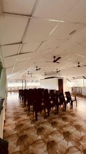 a large room with chairs and birds on the ceiling at BIKI'S PALM VILLA in Kaduturutti +79 photos