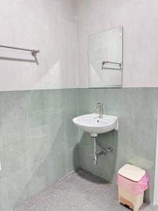 a bathroom with a sink and a toilet at Karon Little House in Karon Beach