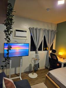 a living room with a computer monitor and a fan at Your Cozy Space in Stanford Suites 3 Brgy Inchican Silang Cavite in Silang