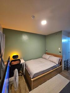 a bedroom with a bed and a table and a desk at Your Cozy Space in Stanford Suites 3 Brgy Inchican Silang Cavite in Silang +31 photos