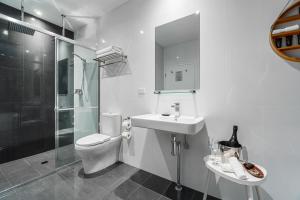 a bathroom with a toilet and a sink and a shower at North Adelaide Boutique Stays Accommodation in Adelaide +34 photos