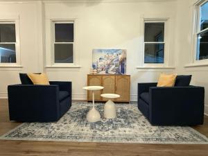 a living room with two chairs and a table at Spacious 4BR Home Pool and Comfort in Columbus