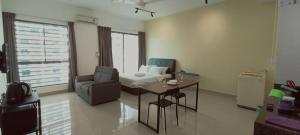 a living room with a couch and a table and a chair at Peace home 03 in Cyberjaya