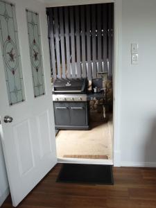 an open door to a kitchen with a stove at Bushland Breeze - Self Contained Unit in Gladstone