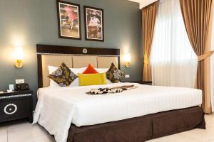 a bedroom with a large white bed in a room at Club Mahindra Mac Boutique Hotel in Bangkok