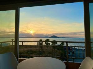 a view of the ocean from a balcony at Udo Daol Pension in Jeju