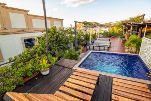a backyard with a swimming pool on a deck at Casa La Bella Samaria Boutique in Santa Marta