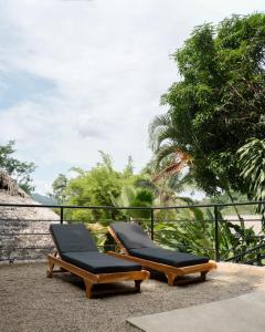 two lounge chairs sitting on a patio at Jungla EcoLuxury Resort in Villeta