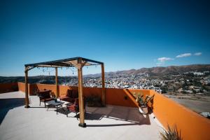 a patio with chairs and a gazebo at Casa del Pintor Guesthouse in Guanajuato