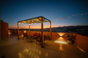 a rooftop deck with a gazebo at night at Casa del Pintor Guesthouse in Guanajuato