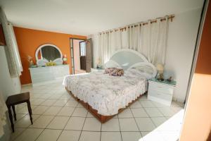 a bedroom with a bed and two dressers and mirrors at Casa del Pintor Guesthouse in Guanajuato